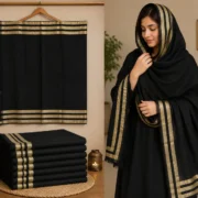 Woman draped in a black embroidered shawl