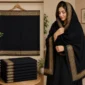 Woman wearing a black embroidered shawl